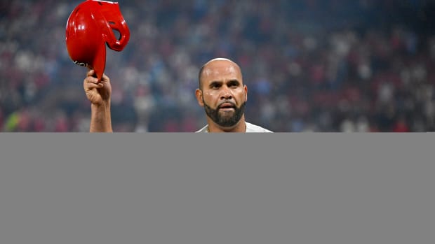 Albert Pujols gives a curtain call to the Busch Stadium crowd after hitting his 701st career home run